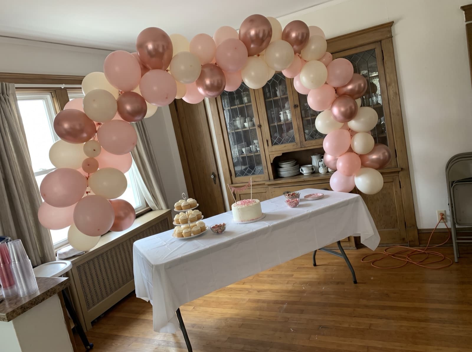 Organic balloon arch in blush, ivory and rose gold over a dessert table